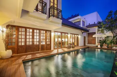 a swimming pool in the backyard of a house at Villa Casa Adeline in Canggu