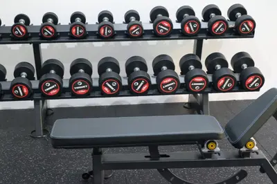 a rack of dumbbells in a gym at Adi Dharma Hotel Kuta in Kuta