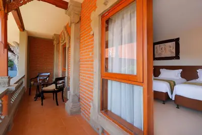 a room with a bed and a window at Adi Dharma Hotel Legian in Legian
