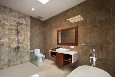 a bathroom with a sink and a shower and a toilet at The Luxury Collection, Monaco Blu in Seminyak