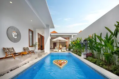 a pool in a villa with a heart shaped swimming pool at The Luxury Collection, Monaco Blu in Seminyak
