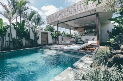 a swimming pool in the backyard of a house at La Payesa in Canggu
