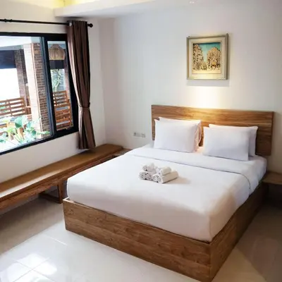 a bedroom with a bed with a towel on it at Metta Agara in Kerobokan