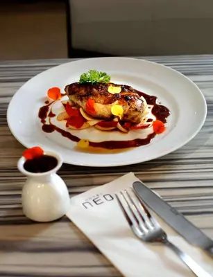 a plate of food sitting on top of a table at Hotel Neo - Kuta, Jelantik in Legian