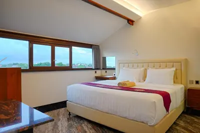 a bedroom with a large bed and a glass table at Kyara Villa Apartments in Canggu
