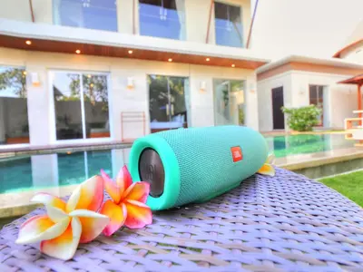 a green camera sitting on top of a table with flowers at Luxury Villa Juno Seminyak in Seminyak