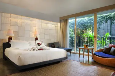 a bedroom with a large bed and a balcony at Cross Paasha Bali Seminyak in Seminyak