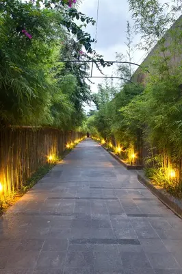 an empty road with lights on the sides at The Nibbana Villas in Seminyak