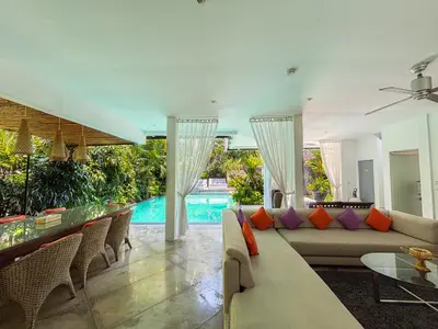 a living room with a couch and a pool at Villa Eindra Seminyak in Seminyak