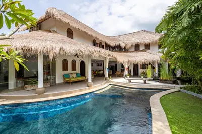 a villa with a swimming pool and a resort at Elina Villas Seminyak in Seminyak