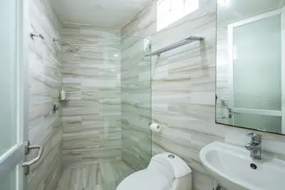 a bathroom with a toilet and a sink and a mirror at Elina Villas Seminyak in Seminyak