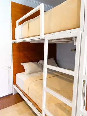 a bedroom with two bunk beds in a room at ALA Hostel in Seminyak