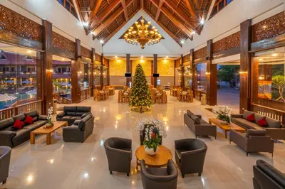 a lobby with a christmas tree in the middle at The Salila Beach Resort in Seminyak