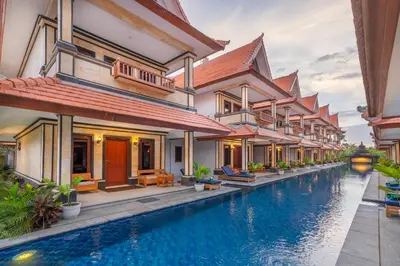 a villa with a swimming pool in a resort at The Salila Beach Resort in Seminyak