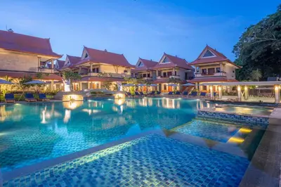 a large swimming pool in front of some buildings at The Salila Beach Resort in Seminyak