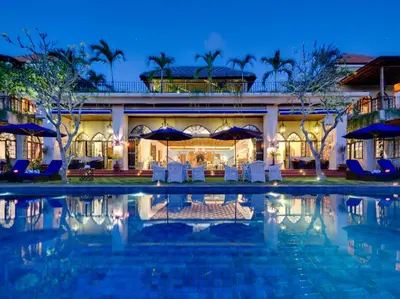 a resort with a swimming pool at night at Sayang d'Amour in Seminyak