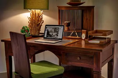 a desk with a laptop computer on top of it at MasBro ART Villas in Seminyak