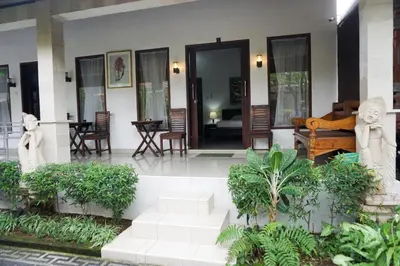 a lobby of a house with stairs and plants at Ary Guest House in Canggu