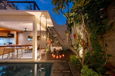 an external view of a house with a swimming pool at Ayona Villa Seminyak by Ini Vie Hospitality in Seminyak