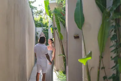 a man and a woman standing in an alley at Ayona Villa Seminyak by Ini Vie Hospitality in Seminyak