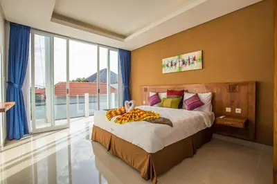 a bedroom with a bed and a large window at Villa Ultima Umalas in Canggu