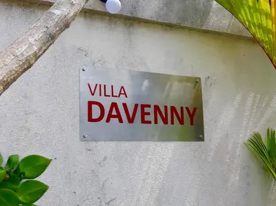 a sign on a wall that reads villa dawnney at Villa Davenny in Seminyak