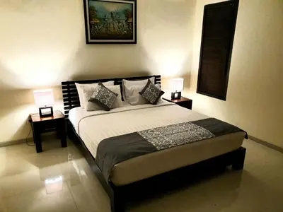 a bedroom with a bed with two lamps on it at Villa Davenny in Seminyak