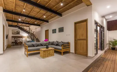 a living room with a couch and a table at Villa Jamu in Seminyak