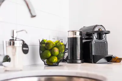a kitchen counter with a bowl of limes and a blender at Villa Chikka in Seminyak