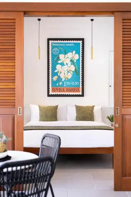 a bed in a room with a table and a chair at Villa Chikka in Seminyak