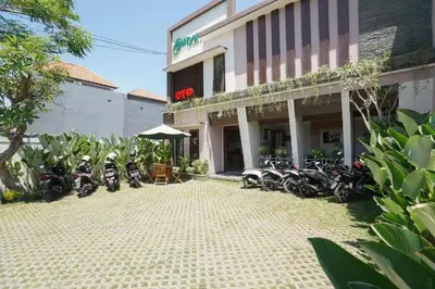 a group of motorcycles parked in front of a building at Capital O 2166 Elitya Stay in Sanur
