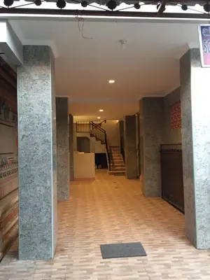 an empty room with a staircase in a building at Dana Homestay in Canggu