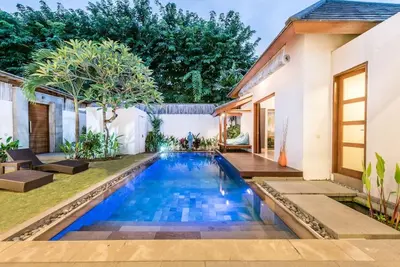 a swimming pool in the backyard of a house at Manis, Luxury 3 Bedroom Heart of Seminyak in Seminyak