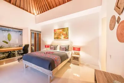 a bedroom with a bed and a desk in it at Manis, Luxury 3 Bedroom Heart of Seminyak in Seminyak