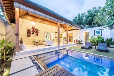 a house with a swimming pool and a patio at Manis, Luxury 3 Bedroom Heart of Seminyak in Seminyak