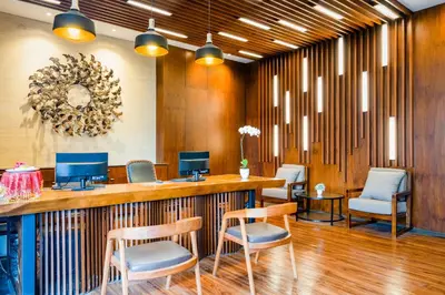 a lobby with a bar with chairs and a table at Del Cielo Villa Seminyak in Seminyak