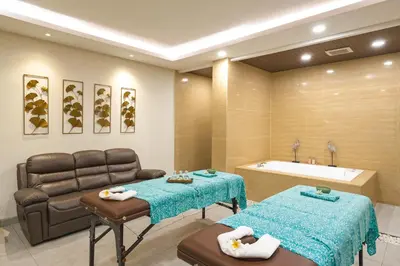 a bathroom with a couch and a sink at Del Cielo Villa Seminyak in Seminyak