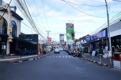 a city street with a car driving down the street at Del Cielo Villa Seminyak in Seminyak