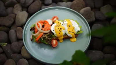 a plate of food with eggs and vegetables on it at Del Cielo Villa Seminyak in Seminyak