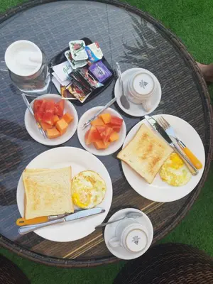 a table with plates of breakfast food on it at D&D homestay in Pesanggaran
