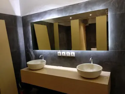 a bathroom with two sinks and a large mirror at XOXO Kuta Legian Hostel in Legian