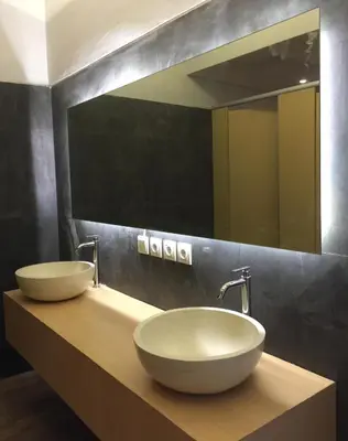 a bathroom with two sinks and a large mirror at XOXO Kuta Legian Hostel in Legian