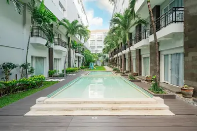 an empty swimming pool in the middle of a building at b Hotel Bali & Spa in Denpasar