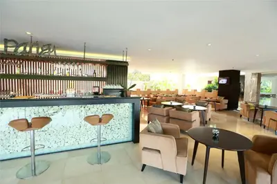 a restaurant with a bar and tables and chairs at b Hotel Bali & Spa in Denpasar