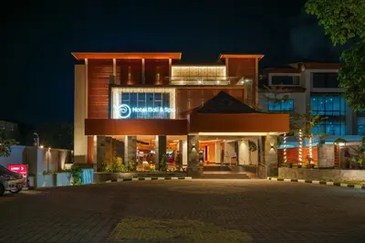 a building with a sign on it at night at b Hotel Bali & Spa in Denpasar