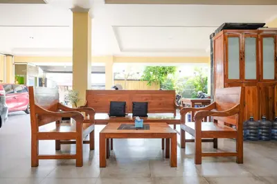 a living room with two chairs and a table at RedDoorz @ Kerta Dalem Sidakarya in Denpasar