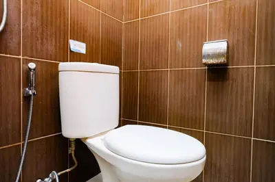 a bathroom with a toilet and a shower at RedDoorz @ Kerta Dalem Sidakarya in Denpasar