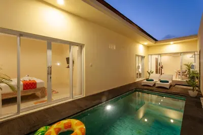 a swimming pool in a house with a bedroom at Villa Julie & Villa Sydney, Seminyak - 2 Bedroom Modern Pool Villas! in Seminyak