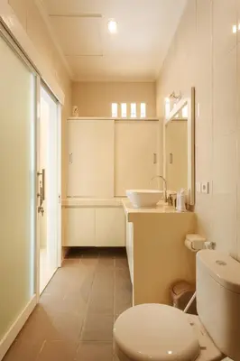 a bathroom with a white toilet and a sink at Villa Julie & Villa Sydney, Seminyak - 2 Bedroom Modern Pool Villas! in Seminyak
