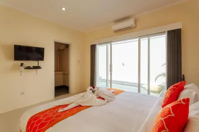 a bedroom with a large bed with a large window at Villa Julie & Villa Sydney, Seminyak - 2 Bedroom Modern Pool Villas! in Seminyak